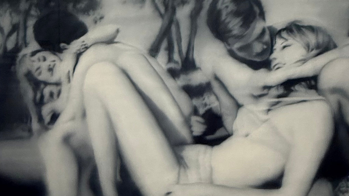 A blurred black-and-white painting by Gerhard Richter of entwined figures in an embrace, photographed at Fondation Louis Vuitton, Paris