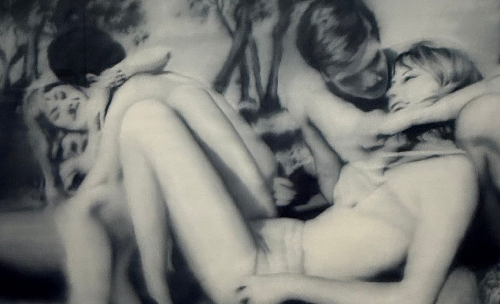 A blurred black-and-white painting by Gerhard Richter of entwined figures in an embrace, photographed at Fondation Louis Vuitton, Paris
